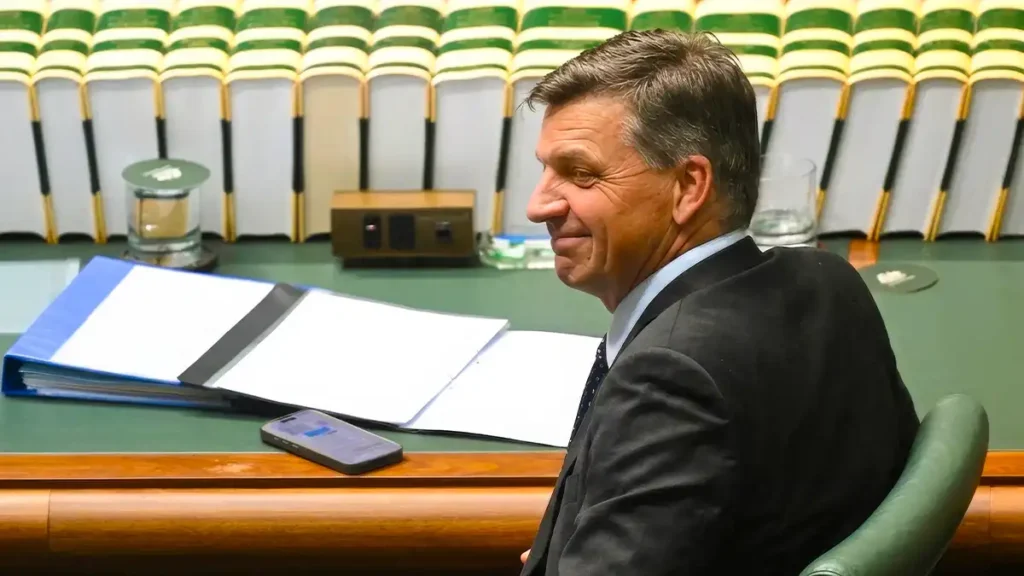 Angus Taylor addresses reporters inside a newsroom studio during a political press briefing.