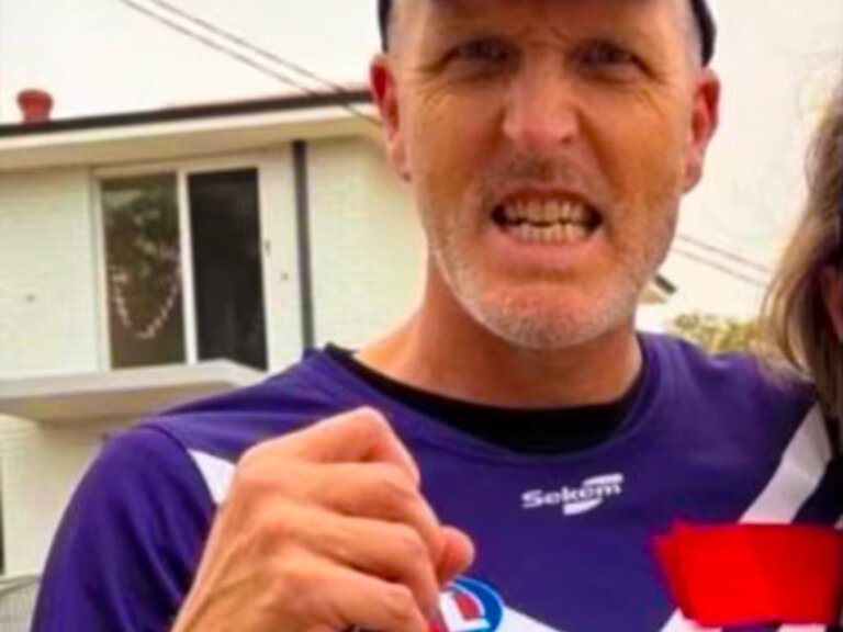 Josh Wilson covers Woodside logo on Dockers jumper