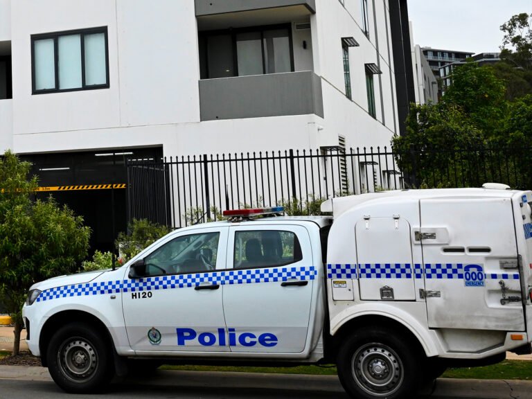 A police car outside the building in Norwest, Sydney, where the 11-year-old boy suffered his fatal injuries. Photograph: Dan Himbrechts/AAP
