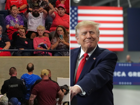Security staff escort a protester from Donald Trump’s South Carolina campaign rally.