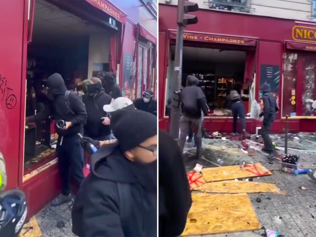 Masked individuals carry bottles from a Paris wine shop during unrest linked to nationwide protests on 17 October 2026.