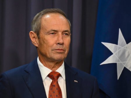 Roger Cook Urges Labor to Scrap Working Holiday Visa Ballot Western Australian Premier Roger Cook speaking at a press conference.